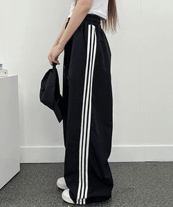Three-line rustling track pants
