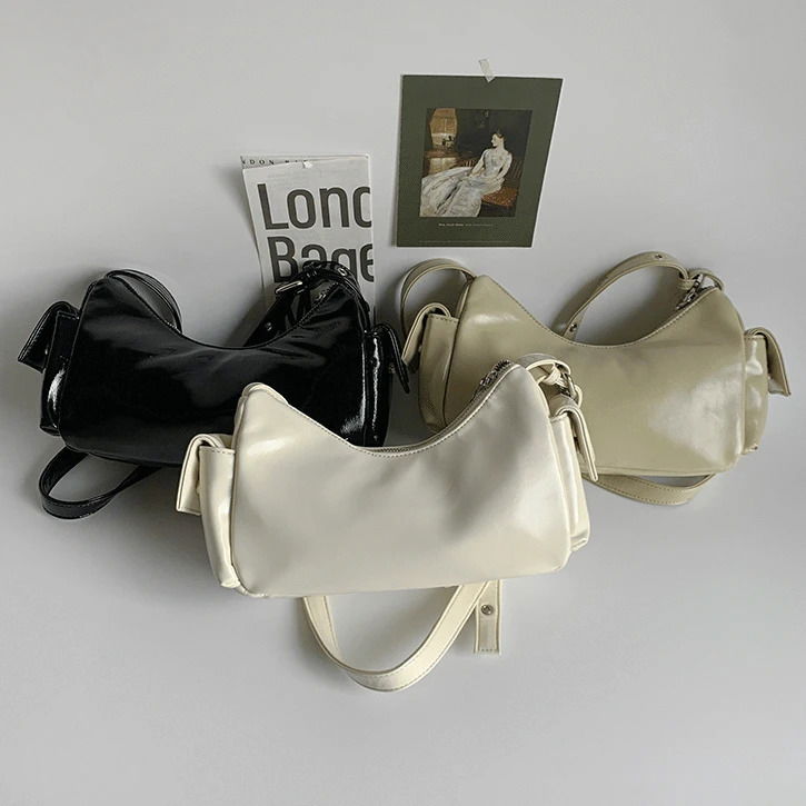Side pocket belted shoulder bag