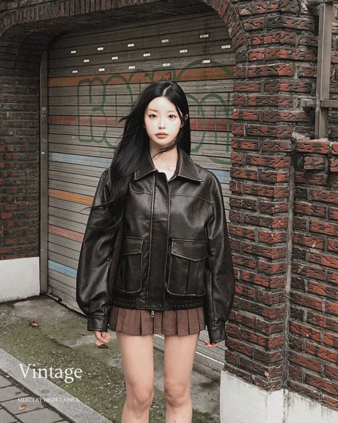 A vintage leather Faded with a two-way zipper pocket, a buttoned collar, and a loose fit.